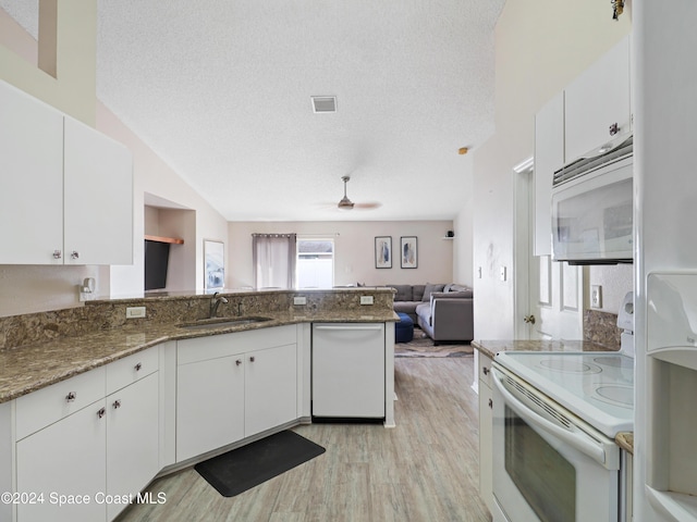 kitchen featuring white appliances, white cabinetry, and sink