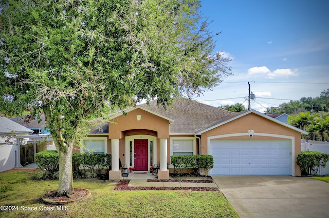 view of front of house featuring a garage and a front yard