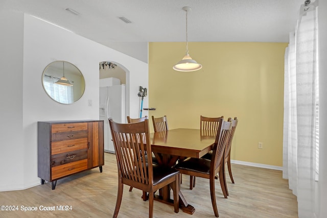 dining space with light hardwood / wood-style flooring