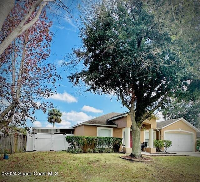 ranch-style home with a front yard and a garage