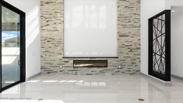 unfurnished living room featuring light tile patterned flooring and a stone fireplace