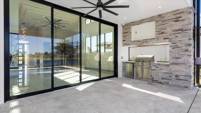 interior space featuring ceiling fan and floor to ceiling windows