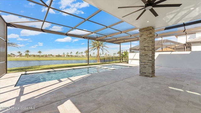 view of pool featuring a water view, a patio area, ceiling fan, and a lanai