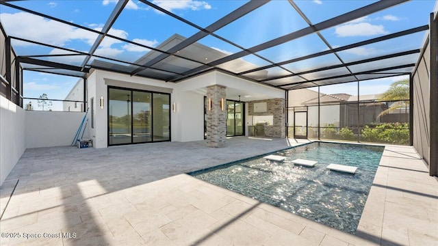 view of swimming pool featuring glass enclosure and a patio area