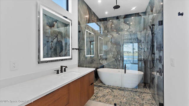 bathroom featuring plus walk in shower and vanity