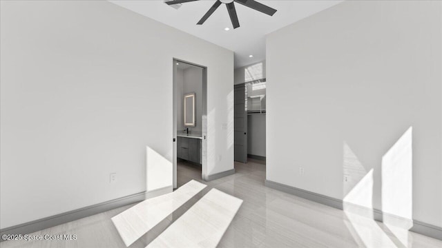 bedroom featuring connected bathroom and ceiling fan