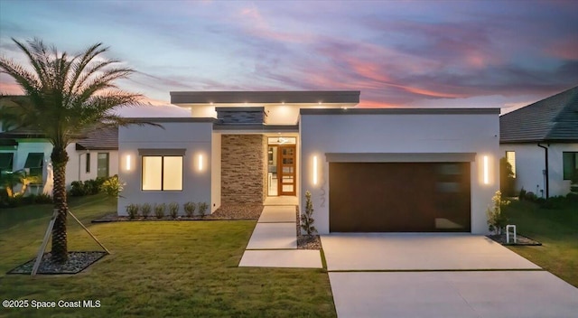 contemporary home with a yard and a garage