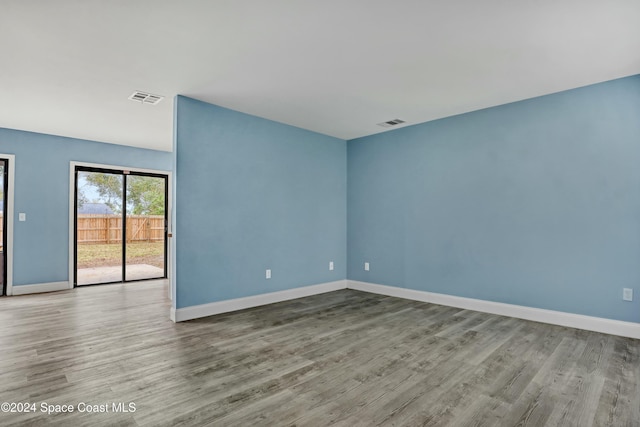 unfurnished room with hardwood / wood-style flooring