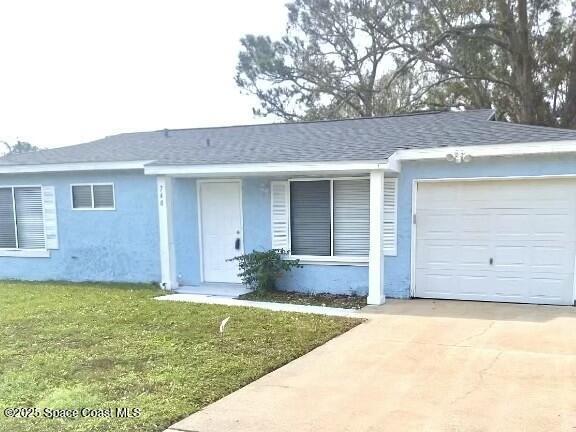 ranch-style house with a garage and a front yard