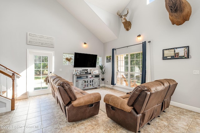 living room with light tile patterned floors and a high ceiling