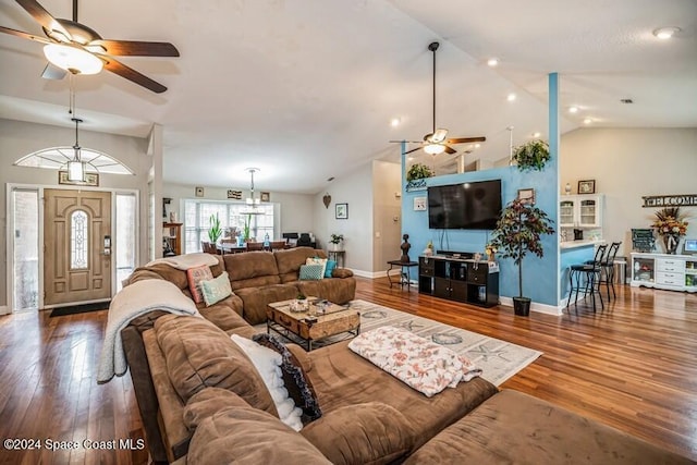 living room featuring ceiling fan, wood-type flooring, and vaulted ceiling