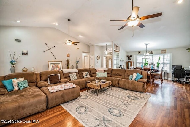 living room featuring hardwood / wood-style floors, ceiling fan, and lofted ceiling