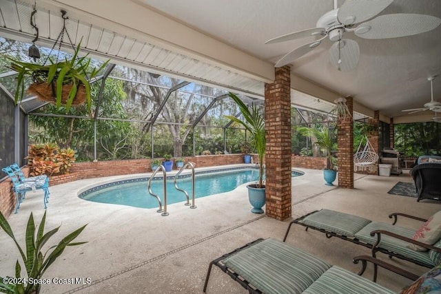 view of swimming pool featuring a patio, ceiling fan, and a lanai