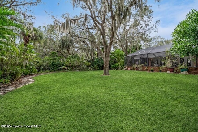 view of yard with a lanai