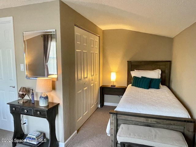 bedroom featuring a textured ceiling, carpet floors, and a closet