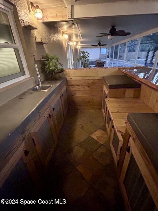 kitchen featuring ceiling fan and sink