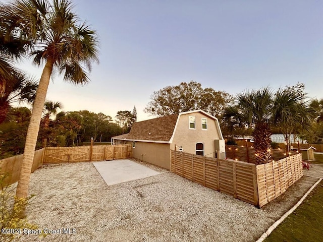 yard at dusk with a patio area