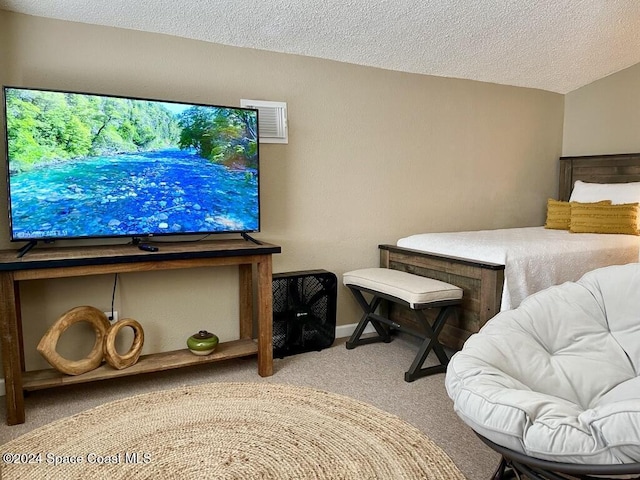 bedroom with light carpet and a textured ceiling