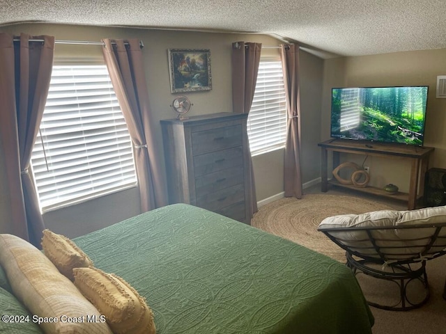 carpeted bedroom featuring a textured ceiling