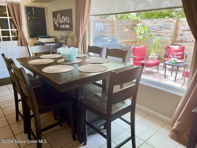 dining area featuring light tile patterned flooring