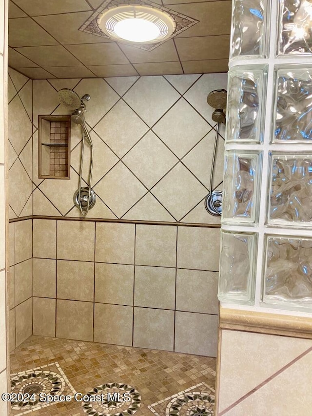 bathroom with a tile shower