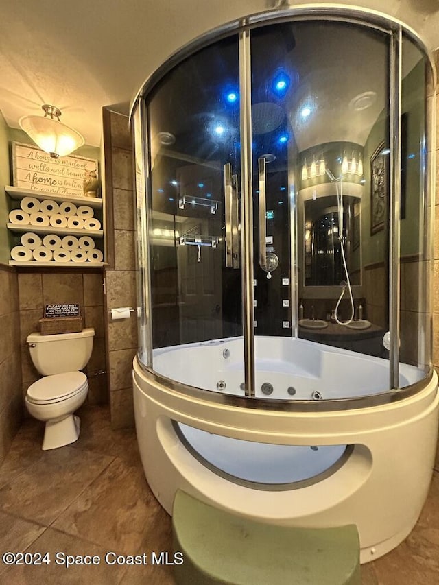 bathroom with a tub, tile patterned flooring, and toilet