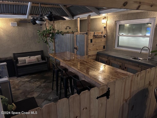 view of patio / terrace with ceiling fan and an outdoor wet bar