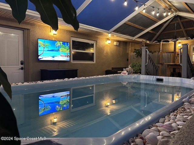 view of swimming pool with ceiling fan