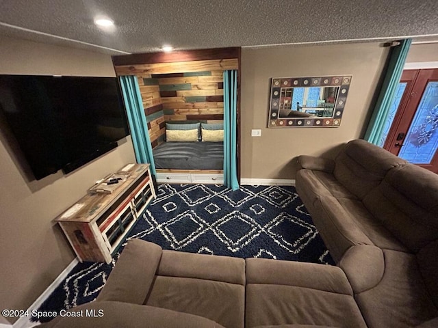 carpeted living room featuring a textured ceiling