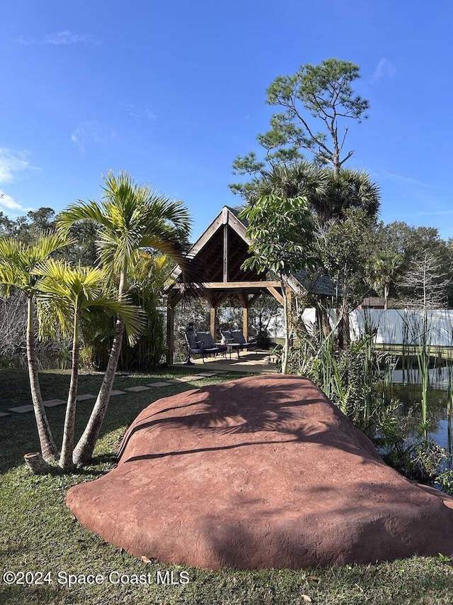 surrounding community featuring a gazebo and a water view