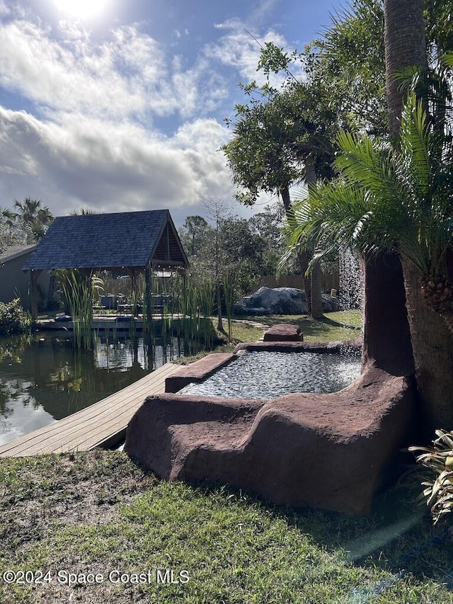 exterior space featuring a gazebo and a water view