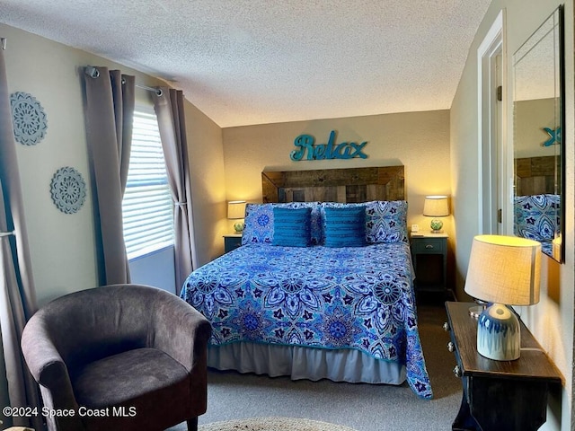 bedroom featuring a textured ceiling and carpet floors