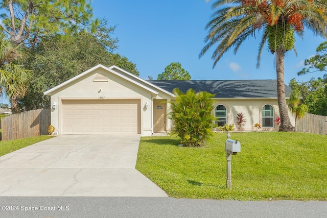 ranch-style home with a front lawn and a garage