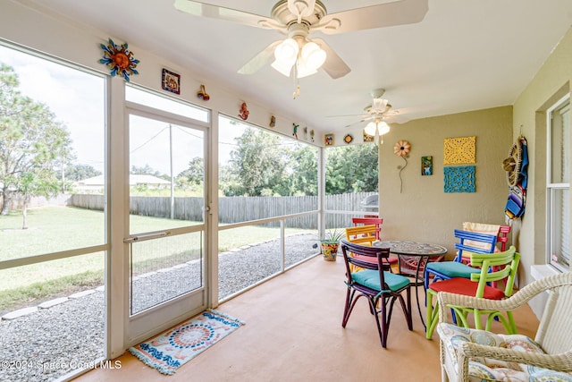 sunroom featuring ceiling fan