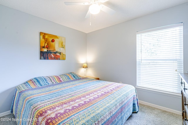 bedroom with light colored carpet and ceiling fan