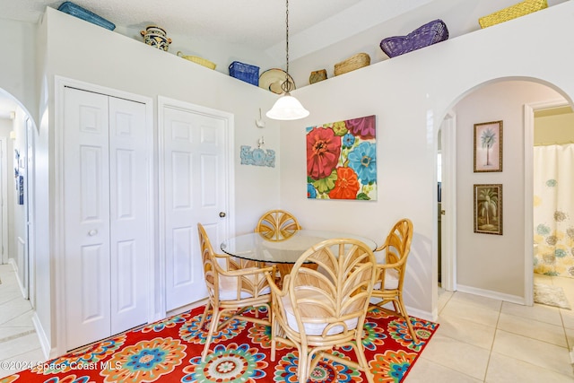 dining space featuring light tile patterned flooring