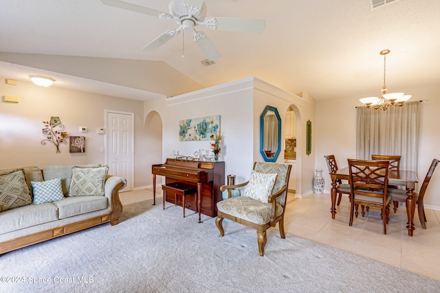 living room with lofted ceiling, light tile patterned floors, and ceiling fan with notable chandelier