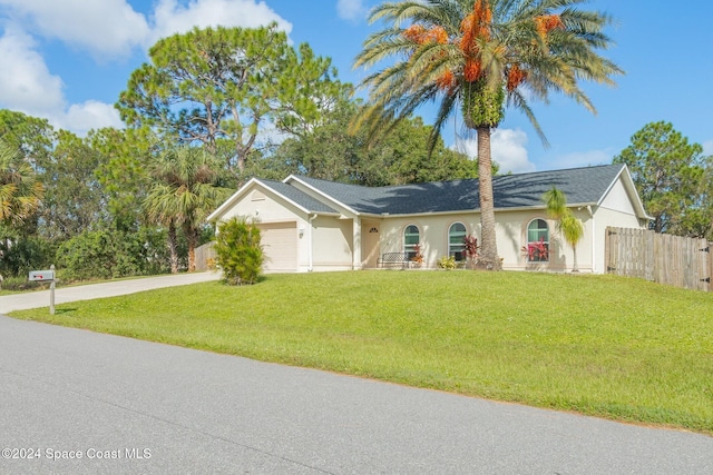 ranch-style house with a garage and a front lawn