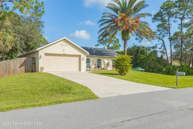 single story home featuring a front yard and a garage