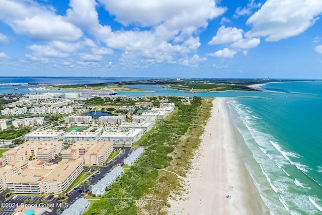 bird's eye view featuring a water view and a beach view