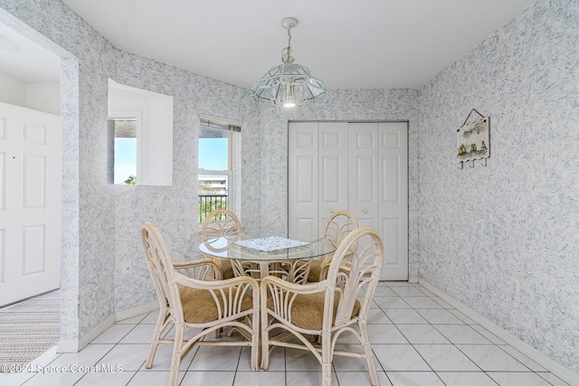 601 Shorewood Dr Unit 402, Cape Canaveral, FL 32920 - dining space with wallpapered walls and light tile patterned floors