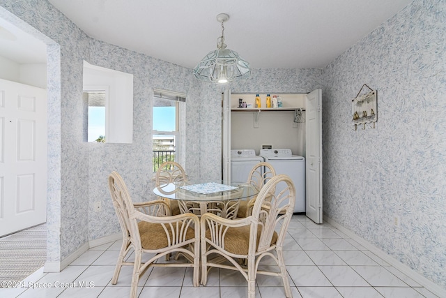 tiled dining room featuring washing machine and dryer