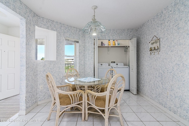 601 Shorewood Dr Unit 402, Cape Canaveral, FL 32920 - dining area with independent washer and dryer, wallpapered walls, and light tile patterned floors