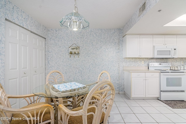 tiled dining area with an inviting chandelier