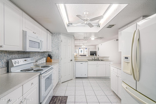 kitchen featuring white appliances, sink, ceiling fan, light tile patterned flooring, and white cabinetry