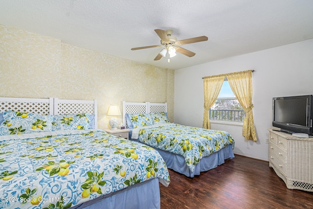 bedroom featuring ceiling fan, dark wood-type flooring, and a textured ceiling