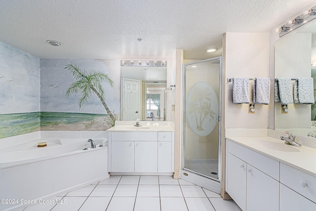 bathroom with vanity, a textured ceiling, tile patterned floors, and separate shower and tub