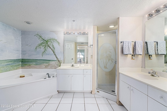 601 Shorewood Dr Unit 402, Cape Canaveral, FL 32920 - bathroom featuring a textured ceiling, a stall shower, two vanities, a bath, and tile patterned flooring
