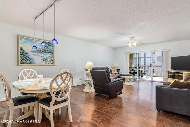 601 Shorewood Dr Unit 402, Cape Canaveral, FL 32920 - dining space with ceiling fan, dark wood finished floors, rail lighting, and a textured ceiling