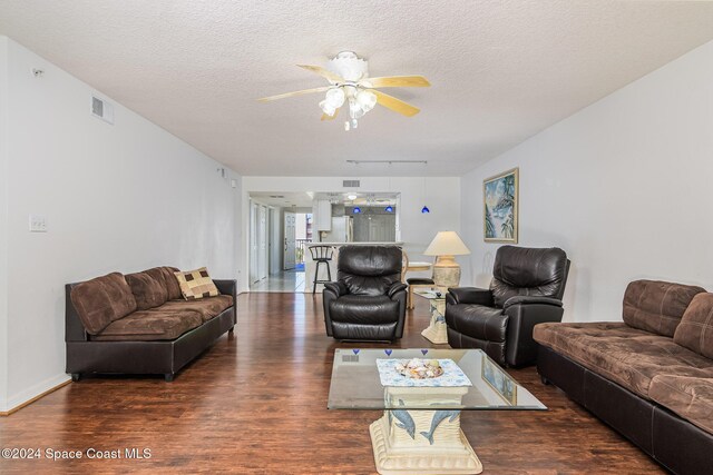 601 Shorewood Dr Unit 402, Cape Canaveral, FL 32920 - living room featuring wood finished floors, a ceiling fan, and a textured ceiling